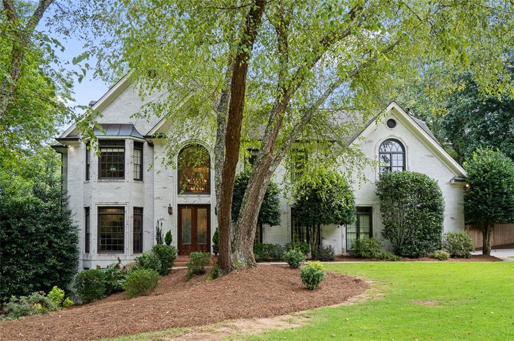 An absolute stunner in the desirable Old Paper Mill neighborhood! This beautifully renovated home offers over 6,000 square feet of living space and is located within the prestigious Cobb County school district, including the renowned Sope Creek and Wheeler schools. Step inside to discover a spacious, open floor plan flooded with natural light and hardwoods throughout. The newly renovated kitchen is a chef’s dream, featuring modern finishes, high-end appliances, and an abundance of storage space. The expansive basement is fully finished, perfect for entertaining, a home theater, or an in-law suite. The luxurious primary bathroom has been thoughtfully redesigned, providing a spa-like retreat. Other updates include a completely remodeled laundry room and beautifully designed wet bar room. This home also boasts a variety of bonus rooms, including a cozy office, a sunroom to enjoy your morning coffee, and a screened-in porch that seamlessly blends indoor and outdoor living. A loft space off one of the bedrooms offers additional flexibility for play or study. Enjoy the convenience of a 2-car garage, plus extra space for a golf cart, making it easy to take advantage of the community's tennis and swimming amenities. This home offers everything you need for comfortable, luxurious living in one of the most sought-after neighborhoods in the area. Don’t miss your chance to make it yours!