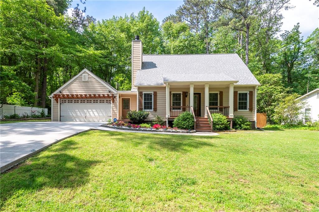 Get ready to be amazed! Meticulously remodeled east Cobb stunner with a guest house! Charming Cape Cod style home with a rocking chair front porch overlooking a beautifully landscaped front yard. Primary bedroom on the main floor with a gorgeous full bathroom featuring beautiful tile work, a frameless shower door, and a double vanity. All new kitchen with wood cabinets, granite counters, stainless appliances, and a tile backsplash. Spacious window-filled dining room with french doors opening to the screened porch. Two secondary bedrooms upstairs and a remodeled full bathroom. Large rear deck overlooking a level, private, and fenced backyard. Recently replaced concrete driveway. Newer roof, water heater, and HVAC. Awesome guest house featuring one bedroom, a full bathroom, a kitchen, laundry space, and plenty of attic storage. The main house is 1,784 finished square feet and the guest house is 625 finished square feet. Optional swim and tennis memberships available at Holly Springs Swim & Tennis Club. This one truly will not last!