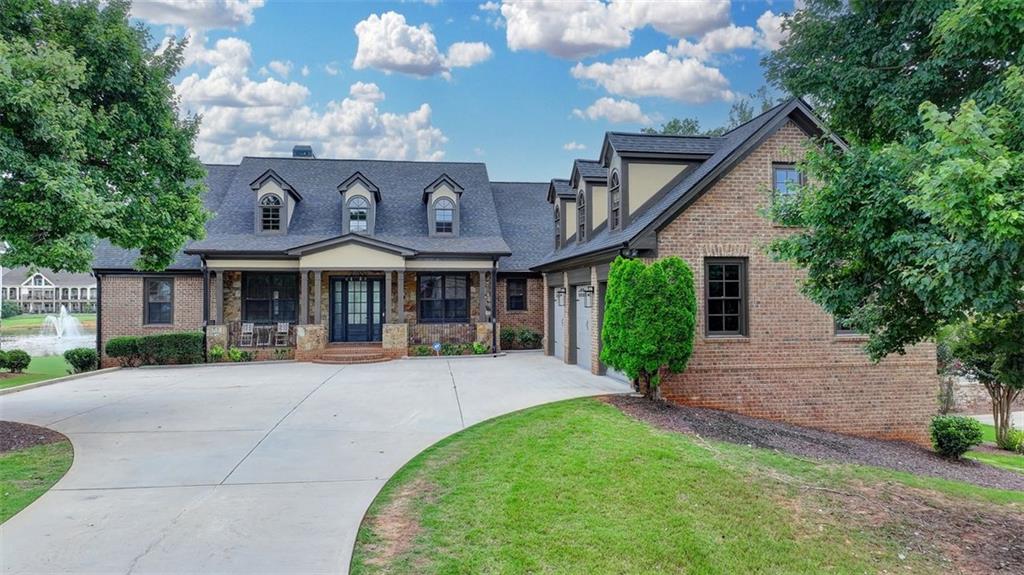 4 SIDED BRICK HOME IN TRADITIONS OF BRASELTON WITH WATER & GOLF COURSE VIEWS!! ONE OF THE BEST LOTS & VIEWS IN THE NEIGHBORHOOD ON HOLE#5 ON TRADITIONS GOLF COURSE** Traditions of Braselton is a prestige, resort-like community with a golf course, it's own restaurant, school, numerous pickleball & tennis courts, fitness center, club house, ponds- fishing allowed, great trails around neighborhood, & is close to shopping and the highway, along with many more amenities! This home boasts a generous 7,400 sq ft w/ 7 rooms and 6.5 baths and MASTER ON MAIN as well as 2 masters! This 3 story home has a bedroom with its own full bath/walk-in shower & it's own HVAC on THIRD FLOOR. The LOWER level is another home of its own & also perfect as an in-law suite with its own master bed/bath, guest room, living room, dining room, guest bathroom, full kitchen, laundry, back patio, and separate access! The LOWER level MASTER BEDROOM has high ceilings with it's own access to the back patio, & the MASTER BATH has a double shower system w/ LED lights and bluetooth speaker systems. The GUEST BEDROOM in the LOWER level is bigger than the master bedroom with a walk-in closet while the GUEST BATHROOM has an updated walk-in shower. The LOWER level has a huge open concept with the kitchen opening up to the living room along w/ a big window in front of the kitchen sink. The LOWER level has it's own HVAC system/thermostat along with many storage areas. It has numerous windows and is lit with sunlight all day & has amazing views of the water and golf course. The MAIN level has a front porch area that leads to the entry foyer with high ceilings and modern, eye-catching light fixtures alongside the dining area which can fit 12+ people. The MAIN LIVING ROOM boasts high, beamed ceilings with an updated sleek modern look with it's black marble tile fireplace which matches with the white paint, grey doors, and black fixtures! Further, the living room connects to the BACK PORCH which is covered with a grand, vaulted ceiling and breathtaking view of the water/fountain, rock bed, and golf course view. The KITCHEN has been updated/modernized with white cabinets, grey kitchen island with a breakfast bar, level 7 quartz countertops w/ continuous backsplash, walk-in pantry, stainless steel vent hood, & all new appliances. The KITCHEN connects to the breakfast room & FAMILY ROOM with another updated, marble tile fireplace along with breathtaking views with 4 GRAND WINDOWS to showcase the VIEW. The JACK & JILL rooms share a bathroom with an updated tub and shower combo! The LAUNDRY ROOM comes with a sink & is on the MAIN level next to the 3 CAR GARAGE. The SECONDARY ROOM on the MAIN level has high ceilings and an updated bathroom with a walk-in shower. The MASTER BEDROOM is oversized with an amazing view from its numerous windows. The MASTER BATHROOM is a masterpiece with a walk-in shower and rainfall shower system with led lights/ bluetooth speakers & standalone bathtub next to a big window. In addition, the rainfall light fixture dripping from the high ceiling of the bathroom completes the amazing vibe. It is connected to the WALK-IN CLOSET with it's HIS & HERS closet system. The ENTIRE HOME has been UPDATED w/ brand new flooring, all the bathrooms have been completely updated (even new toilets for every single bathroom), all new fixtures (light & door fixtures, thermostats, smoke detectors, door hinges & seals, outlets, etc.), fresh new paint, new tiles on main level back porch, entire exterior pressure-washed/painted, entire interior freshly painted, brand new roof, new gutters, rain drainage system has been rerouted/improved, HVAC systems & water heaters are NEW, garage has been epoxy painted, and many many more updated features! Also, the driveway was pressure washed & can fit up to 10 cars! Like a NEW HOME in that the entire home was gutted except for some drywall & been completely updated inside and out!