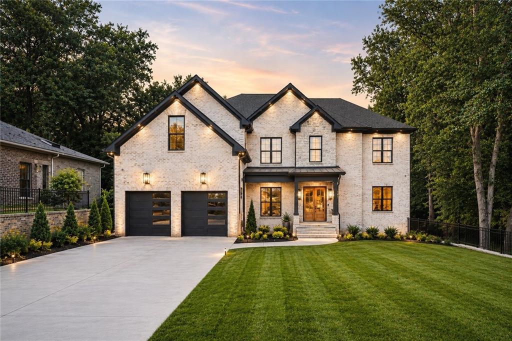 Contemporary brick exterior featuring a dark gray shingle roof and black frame windows