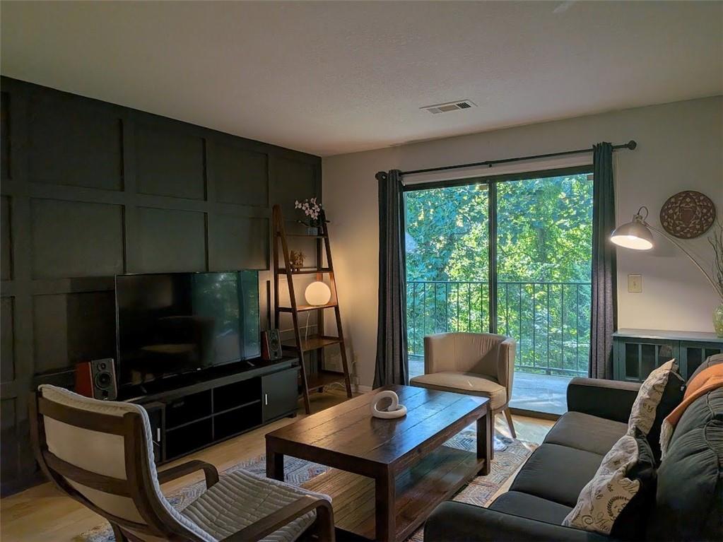 Living area with modern wall molding and french doors leading to patio