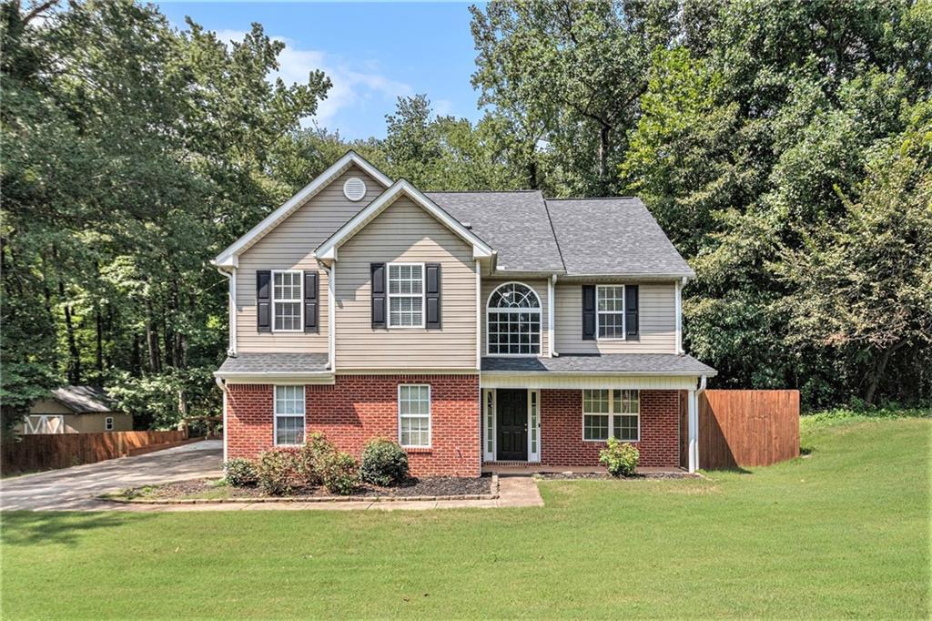 Your ideal home is here—set on a generous 1.56-acre private lot in the well-established Barrington Farms community. This 4-bedroom, 2.5-bath home offers the perfect blend of space, comfort, and privacy. Inside, you'll find stone countertops in the kitchen, and a convenient upstairs laundry room near all the bedrooms. The large family room features a cozy fireplace and opens onto a spacious deck that overlooks the serene backyard—ideal for entertaining or simply unwinding. An additional storage building is included, and the backyard offers a truly private setting that’s hard to find. Don't miss this rare opportunity to own a home with land, space, and charm in a desirable location!