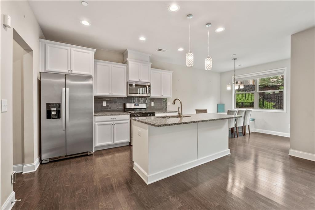 Imagine pulling into 207 Magnolia Creek Way and stepping into the most spacious, serene townhome in Spring Creek Place—where square footage soars, style shines, and not a whisper of Hwy 92 traffic disturbs your peace. This is the only four-bedroom Lexington floor-plan in the complex, boasting 2,498 sq ft of elevated living.
WHAT MAKES 207 MAGNOLIA CREEK WAY UNRIVALED?
• +569 sq ft of Flex Space: A light-filled third-floor loft/flex room with its own ensuite bath becomes your home office, 4th bedroom, guest suite, gym, or media haven—options the neighboring three-bedroom homes simply can’t match.
• Total Indoor Quiet: Unlike other units that back up to the Hwy 92, this gem delivers quiet tranquility inside making it a true retreat.
• Just over 1-mile away is beautiful downtown Woodstock and all that is has to offer.
SMARTEST PRICE PER SQUARE FOOT:
• Current competitor: 130 Maple Creek Way—1,930 sq ft listed at $449,900 (or $233.23/sq ft)
• Recent April Closings: Two 3-bedroom units at 1,909 sq ft sold for $420k (or $220/sq ft)
• Your Advantage: At $465k—or $186.15/sq ft—you get nearly 600 extra square feet of flex space on the 3rd floor for $34–$47 less per square foot.
ELEVATED FINISHES & THOUGHTFUL DESIGN:
• Designer’s Palette: Rich hardwood floors, custom-selected hues, and walls of windows that flood every corner with daylight.
• Gourmet Island Kitchen: Quartz countertops, stainless steel appliances, and a generous walk-in pantry ready for family dinners or entertaining.
• Owner’s Retreat: The spa-inspired en-suite bath features double vanities, an oversized shower, huge closet, and a cozy sitting nook.
• Private Backyard Sanctuary: Fenced-in, professionally landscaped, fully fenced, and adorned with vibrant blooms and evergreens to ensure year-round privacy.
• Move-In Ready: Painted and clean, 2-car garage w/myQ smart garage door opener hub & entry door, plus extended driveway, built-in bookcases, built-in bench in the eat-in kitchen, entry foyer w/shiplap, elegant faux-wood blinds, energy-efficient construction—and appliances for a true turnkey experience.
• Homebuyer Incentive: Up to $23,750 in down-payment assistance available through our Preferred Lender for qualifying buyers.
At 207 Magnolia Creek Way, you’re not just buying a home—you’re stepping into a quieter retreat, claiming unmatched space, and securing the smartest value in the neighborhood, with convenient accessibility to downtown Woodstock . Ready to elevate your lifestyle? Come tour the unit and make this exceptional townhome yours.