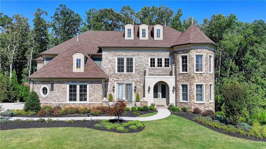 SELLER OFFERING $20,000 TOWARD BUYER'S CLOSING COSTS/OR RATE BUY-DOWN!! Welcome to this stunning, nearly-new home situated on the 9th fairway of the Rees Jones-designed Echelon Golf Club! Boasting over 8,000 square feet of exquisite finishes, this residence offers space and luxury for everyone. Step into the impressive two-story foyer with a grand staircase and beautiful white oak flooring throughout the main level. To your right, you'll find a spacious home office with glass French doors and a closet for convenient storage. To the left, the banquet-sized dining room provides the perfect setting for memorable gatherings and entertaining. A well-appointed butler's pantry features custom cabinetry and quartz countertops, making it easy to serve friends and family. The chef's kitchen is a true dream, equipped with stainless steel appliances, including a six-burner Cafe gas cooktop, double ovens, built-in microwave, pot filler faucet, and a French door refrigerator. The enormous center island offers ample counter space and seating, while custom-painted cabinetry ensures storage for all your culinary needs. An adjacent walk-in pantry with solid wood shelving provides even more space for your family's essentials. Open to the kitchen is the inviting keeping room, complete with a stone fireplace and tray ceiling. Step out onto the spacious covered composite deck or the open deck ideal for grilling and enjoying breathtaking views of the pristine golf course. The two-story great room features another stone fireplace and soaring glass windows  overlooking the fairway.  A guest bedroom with a full bath and a powder room are conveniently located on the main level. Upstairs, accessible by one of two staircases, you'll discover four generous bedrooms. The Primary Suite offers a grand entrance, a large bedroom, an elegant sitting room with fireplace, white oak flooring, and a spa-like bath with a glass-enclosed shower, separate soaking tub, dual vanities, and beautiful custom cabinetry with linen storage. One bedroom has a private bath, while the other two share a bath, each with its own vanity. The finished terrace level is perfect for entertaining large groups, featuring an expansive wet bar with dishwasher, under-counter refrigeration, custom cabinetry, quartz countertops, and a full-size refrigerator. Walk out to a deck overlooking the golf course, or enjoy the recently added home theater ideal for sports and movie nights! Echelon Golf Club is ranked 11th out of 400 Georgia courses by Golf Digest, offering players a formidable test of skill across rolling hills, varied elevations, and stunning vistas on its 600-acre property.