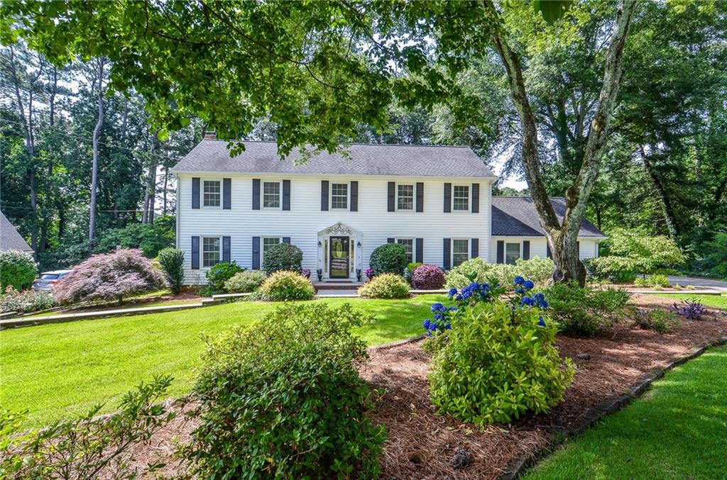 Welcome to the Hanarry West Neighborhood! This picture-perfect white Colonial-style home with classic black shutters and blooming hydrangeas that greet you from the curb. Tucked away at the end of a quiet cul-de-sac, this 4-bedroom, 2.5-bath gem offers timeless charm and flexible living space inside and out.
The spacious eat-in kitchen features a center island and flows easily into a large fireside family room with built-ins. A generous formal living room offers versatile flex space—perfect for a home office, playroom, or studio—while the separate dining room is ideal for hosting holidays and special dinners. The sunroom is a true highlight, flooded with natural light and complete with built-in bench seating for cozy mornings or afternoon reading.
Upstairs, you'll find four bedrooms including a comfortable primary suite, and outside, the backyard is ready for fun with a playset, storage shed, and plenty of room to roam.
Optional neighborhood swim and tennis are just a short walk away. Zoned for top-rated Camp Creek Elementary, Trickum Middle, and Parkview High, this home is also conveniently located near Main Street Lilburn's shops, restaurants, and Lilburn City Park, which hosts free concerts, food trucks, and community events throughout the year.
Easy access to CDC, Emory University, and Decatur, with no mandatory HOA and no rental restrictions—a rare find in such a sought-after location!