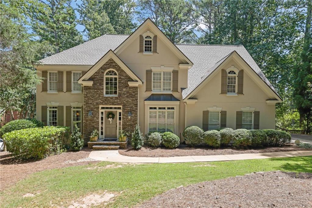 Nestled in Milton’s coveted Wood Valley subdivision, this beautifully updated home blends timeless elegance with modern comfort. With no annual HOA, top-rated schools, and direct access to the upcoming Milton City Park & Preserve, the location is truly unmatched.
The newly renovated kitchen is the heart of the home, featuring custom cabinetry, quartz counters, stainless appliances, and a large island that flows seamlessly into the great room. Step outside to an extended covered deck with fireplace—perfect setting for cozy evenings, lively gatherings, or game day under the stars.
A dramatic two-story foyer and guest suite on the main level add both style and function. Upstairs, a serene primary suite is complemented by three spacious bedrooms with private baths. The finished daylight basement offers a fireplace, wet bar, bedroom, full bath, and generous closet space—ideal for guests or gatherings.
With recent updates including a new roof and water heater, this move-in-ready residence is a rare opportunity in one of Milton’s most desirable settings.