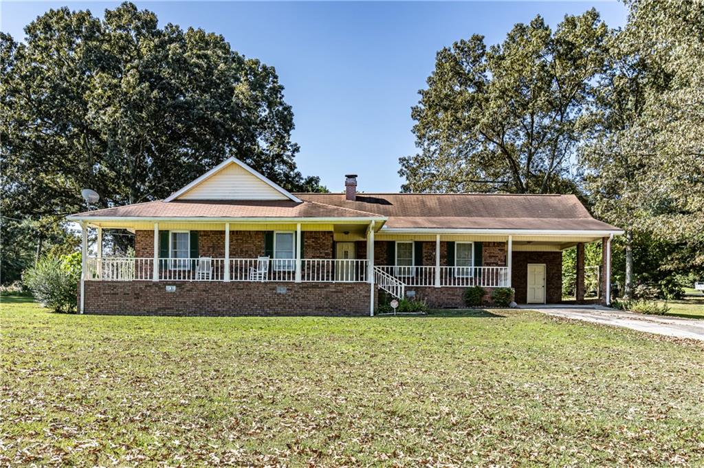 Welcome to this charming 3-bedroom, 2-bath brick ranch in Silver Creek! Enjoy serene country views from the inviting front porch overlooking rolling pastures. Inside features hardwood floors, a cozy fireplace, and an open concept kitchen that flows into the dining area. Bedrooms are spacious, and a screened-in porch offers a perfect spot to relax. The large backyard includes a fenced in area for pets and a barn for storage or a workshop. This well-maintained home is move-in ready and offers quiet country living with plenty of space to enjoy!
