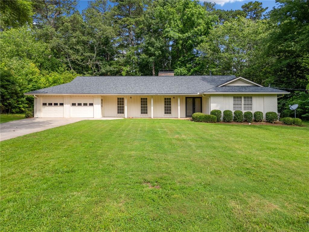 Amazing find in a terrific East Cobb neighborhood. Needs a little love and updating, but the bones are so good! This sprawling ranch floorplan has beautiful hardwood flooring throughout living room, dining room, family room, kitchen and breakfast nook. Tile and vanities in both bathrooms. Kitchen has lots of cabinet space and countertops have been updated to granite. Formal dining room opens to the living room, spacious family room with fireplace and built in bookshelves. Expansive back porch is screened in and overlooks private backyard with scenic woods. Pope School Districk. Great East Cobb location, so close to Johnson Ferry. You won't want to miss the opportunity to update this one to your liking and will appreciate that it's priced accordingly.