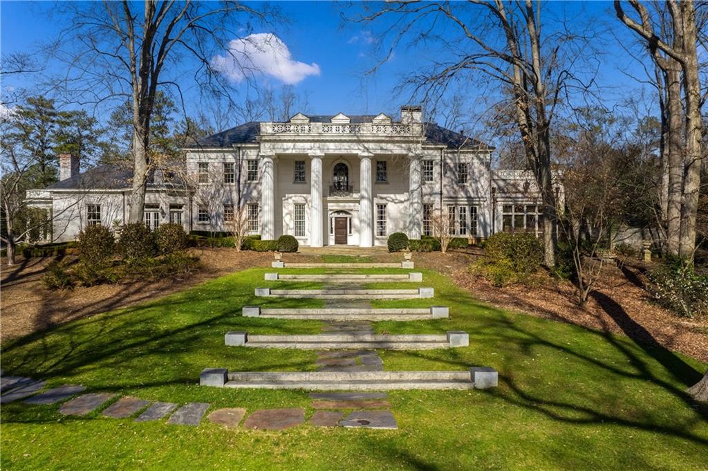 Exceptional gated estate in the heart of Buckhead.  Originally constructed in 1926, this Greek Revival estate known as "White Oaks,” underwent a full renovation and new addition completed by the Garrett Group in 2014.  Situated on almost 4 acres, the exquisite custom details and craftsmanship throughout this home make it a unique work of art.  Staying true to its classic architectural style, architect Laura Howard set out to preserve the essence of the original estate while updating the home for state-of-the-art, modern living. Perfect for entertaining, the main level flows beautifully with views to the grounds from every room.  Walnut doors lead to both the Dining Room and Living Room.  The main Kitchen serves as the central point and is complete with a separate Chef's Kitchen   The upper level in the main house offers a spacious Master Suite, Sitting Room with spectacular views of the grounds, two Guest Suites and Media Room. The substantial addition to the property includes a new two-story Family Room opening to the Library above, a Junior Master Suite, an additional Guest Suite and separate caretakers quarters.  The beautiful and well-manicured grounds offers significant landscape design complete with lush private gardens, reflecting pool, pool side cabanas, fountain, rotunda and outdoor dining and entertaining space. Additional amenities include Wine Cellar, Billiards Room, Home Gym and Sauna, and Auto court with 6 car garage.  House Generator, Crestron Lighting system, and elaborate Security System also included.  Exquisite details and meticulous design, combined with an extensive collection of fine art and antiques makes this one of the most unique properties in all of Atlanta.