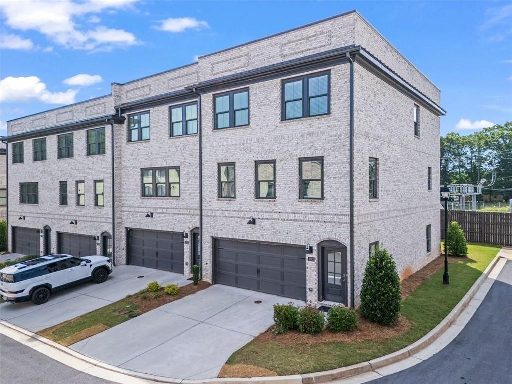 This elegant 3-story townhome is located in the gated Gardendale community in downtown Duluth—just steps from restaurants, shopping, and entertainment. Built in 2021 and impeccably maintained, this 2,696 sq ft home offers 4 bedrooms, 3.5 bathrooms, and a 2-car garage. The terrace level features a private in-law suite with backyard access, while the main level is ideal for entertaining with a spacious great room, modern electric fireplace, and luxury vinyl floors. The chef's kitchen showcases 42" white cabinets, soapstone countertops, stainless steel appliances, and a large island, opening to a private deck. Upstairs, the primary suite includes a custom walk-in closet, wood accent wall, and spa-like bath. Smart home features provide remote access to climate control and security. A perfect blend of style and smart living—schedule your showing today!