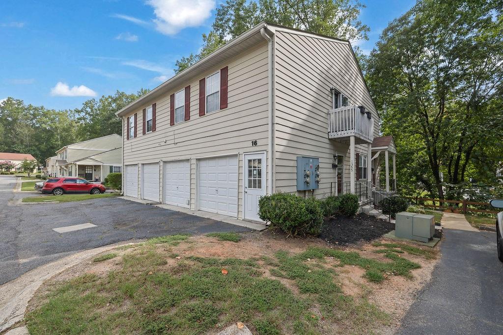 Must see 2br/1ba condo with open floor plan, eat in kitchen with stainless steel appliances and breakfast bar overlooking balcony and yard. Whirlpool tub, 1 car garage with interior entry, and additional parking pad steps from the front door. HOA fees include water, hazard insurance, pest, and termite control. dwelling exterior, trash p/u, and dog park. All this and minutes to Marietta Square, Truist Park, Kennesaw Mountain, and more. Show today! Photos coming soon.