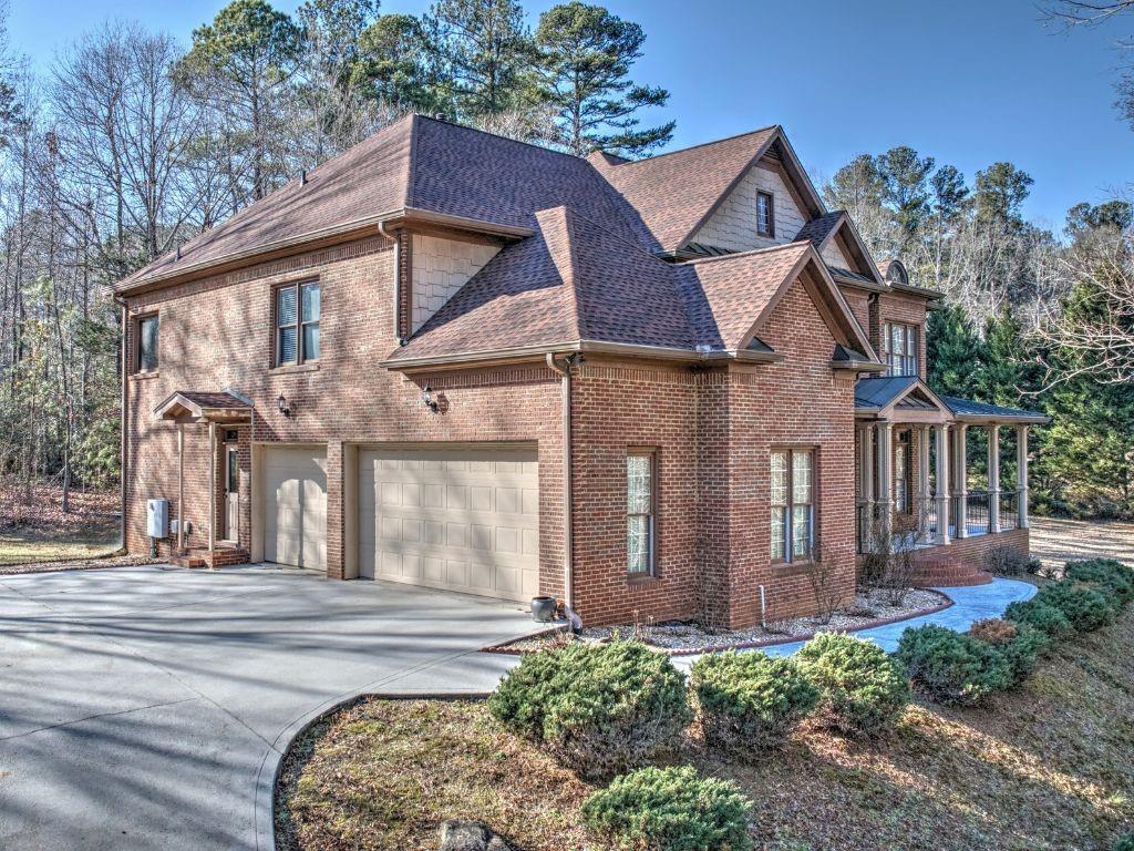 Nestled on over two acres in the Archer school district, this well-maintained, custom-built home offers privacy and convenience. The private driveway welcomes you to a home featuring an open floor plan, a two-story foyer, and hardwood floors on the main level. The main level includes a 12x 13 bedroom and full bath, while the upstairs boasts a luxurious owner's suite with a sitting room and 3 additional bedrooms. A three-car garage and peaceful surroundings complete this home. Enjoy being just minutes from Tribble Mill Park, top schools, and Sugarloaf Parkway. The large unfinished terrace level is a blank canvas, waiting for your finishing touches to transform it into an incredible walk-out space that leads directly to the spacious backyard- perfect for entertaining or relaxing in privacy.