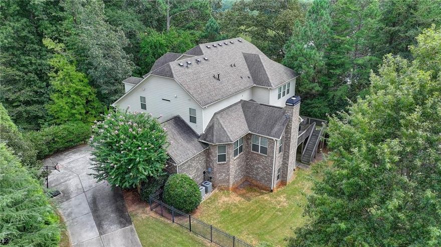 Elegant Living in The Oaks on Charlotte Drive - Welcome to 910 Reece Road, a beautifully designed 6-bedroom, 5-bathroom residence set on nearly an acre of wooded privacy in one of Alpharetta’s most desirable communities. Built in 2012, this thoughtfully crafted home combines timeless elegance with modern comfort, making it ideal for both everyday living and entertaining.

Step inside and discover a flowing floor plan filled with natural light and designer finishes. The main level features a warm and inviting family room with fireplace, a formal dining area for gatherings, and a guest bedroom with full bath—perfect for hosting family and friends. The heart of the home is the stunning kitchen, complete with an oversized island, abundant cabinetry, and premium appliances. A seamless connection to the breakfast area, keeping room, and deck makes this space the hub of daily life.

Upstairs, the spacious primary suite offers a peaceful retreat with a spa-like bathroom and generous walk-in closet. Three additional bedrooms and two full baths provide plenty of room for everyone.  The finished terrace level expands the living space with multiple areas for recreation, a media room, or even a home gym—designed to adapt to your lifestyle needs.

Outdoors, enjoy the wooded backdrop from the expansive deck, creating the perfect setting for relaxation or entertaining. A three-car garage and nearly one acre of property provide both practicality and privacy, with ample space for a future pool if desired.

Located in The Oaks on Charlotte Drive, this home offers unmatched convenience. Top-rated schools—Crabapple Crossing Elementary, Northwestern Middle, and Milton High—are just minutes away, along with the shopping, dining, and entertainment of Crabapple, Downtown Alpharetta, and Avalon.  910 Reece Road is a rare opportunity to own a move-in ready home that balances luxury, comfort, and location. Schedule your private tour today and experience the lifestyle you’ve been waiting for.