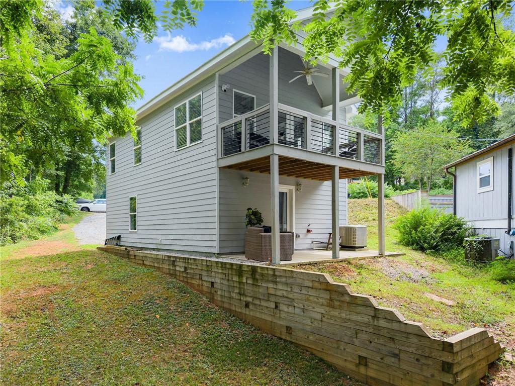 Lake Lanier Living at Its Best! Welcome to this stunning 2-bedroom, 2-bathroom home built in 2020, offering year-round views of Lake Lanier and access to fantastic community amenities. Located in a gated community, enjoy peace of mind along with a boat ramp, dock, and pavilion. Step inside the upper level and you’ll find a bright, open floor plan featuring a gorgeous white kitchen with a large island, granite countertops, and stainless steel appliances. The kitchen overlooks the spacious living room with vaulted ceilings and direct access to a covered deck with breathtaking lake views - the ideal spot for morning coffee or evening relaxation. Also on the upper floor is a bedroom and a full bathroom, along with a conveniently located laundry room. Downstairs, you'll discover a second bedroom and full bath, along with a covered patio - great for guests, roomates, or multi-generational living. The oversized garage offers ample space for lake toys, storage, or a workshop. Boats allowed to be parked on property! Whether you’re seeking a full-time residence or a weekend getaway, this property offers a rare combination of modern comfort, water access, and natural beauty. No rentals allowed in the neighborhood.