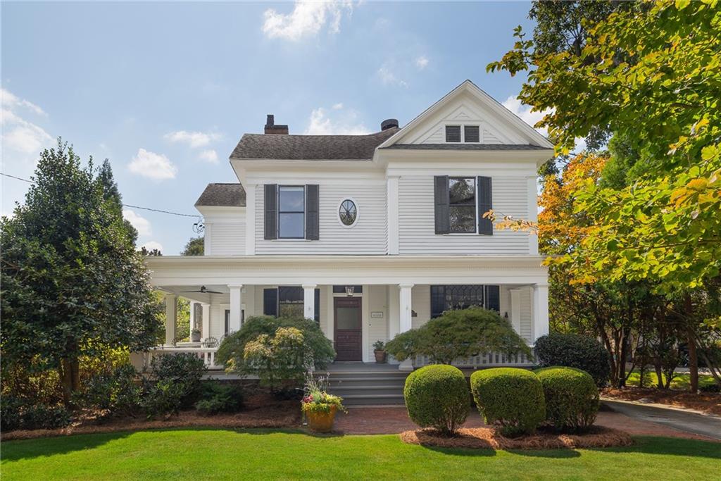 Nestled just steps from the lively Decatur Square, this magnificent turn-of-the-century Victorian manor captures the essence of a bygone era while seamlessly blending modern comforts. With four generously sized bedrooms and 3.5 bathrooms, this meticulously maintained home is a showcase of timeless architectural details and classic elegance.
A welcoming wrap-around porch beckons as you approach, providing the ideal setting for morning coffee or evening relaxation. The parlor entryway showcases original fir millwork, setting a captivating tone of historic charm that pervades the entire residence. High ceilings reaching 12 feet and heart-pine floors create an inviting atmosphere in the formal dining room, making it perfect for hosting gatherings and special occasions.
The kitchen is a culinary enthusiast's dream, recently remodeled to feature high-end appliances, a generously sized granite island, and a chef's dream stove-hood. The home also boasts a picturesque library and an adjoining formal living area, both equipped with custom fireplaces, offering cozy spaces for relaxation and entertainment.
Abundant natural light graces the family room through tall windows, illuminating a functional office nook. Upstairs, a spacious primary suite awaits, with dual closets and breathtaking views of a 40-foot lap pool, complemented by a serene brick patio, offering an idyllic outdoor oasis.
Situated in the heart of Decatur, this property enjoys unparalleled access to the vibrant Decatur Square, renowned for its eclectic mix of shops, restaurants, and cultural events. This prime location also provides easy access to nearby amenities, schools, and parks, making it a coveted destination for those seeking the perfect blend of historic charm and modern convenience.