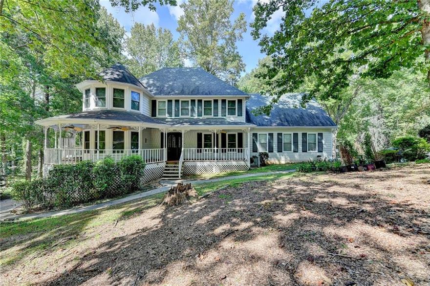 *** Brand NEW carpet is installed***Welcome to 402 W Leslie Court — a standout Victorian-style home tucked into a quiet corner lot in the heart of Woodstock. From the moment you arrive, the inviting wraparound front porch sets the tone for what’s inside: space, charm, and serious lifestyle appeal.

Inside, you’ll find 3 spacious bedrooms, 2.5 baths, and a bright, open layout made for modern living. The kitchen boasts stainless steel appliances, updated counters, and opens effortlessly to the dining and living areas — perfect for hosting or everyday hangouts. A cozy fireplace and views of the private backyard complete the main living space.

Upstairs, the oversized primary suite is a true retreat, complete with walk-in closet, double vanity, and a bonus room ideal for an office, nursery, or media space — with its own private staircase. The partially finished basement offers even more flexibility, with space for a home gym, workshop, or rec room, plus extra garage/storage space.

Outside, enjoy a massive flat backyard with direct private lake access — a rare feature in this community. A fully wired detached “she-shed” adds even more versatility for a studio, home office, or retreat. Garden space, mature trees, and a spacious deck make the outdoor areas just as livable as the inside.

This is more than a home — it’s a lifestyle. Schedule your showing today and discover everything this unique property has to offer!