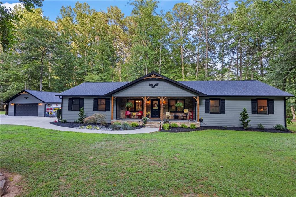 If you’ve been dreaming of a home on the water, this is your moment! Nestled right along the scenic banks of Pigeon Creek, this fully renovated 4-bedroom, 3-bath beauty offers the perfect mix of comfort, privacy, and natural surroundings, all just 10 minutes from downtown Dawsonville and 20 minutes to Highway 400. Outdoor lovers will be right at home here, just minutes from Amicalola Falls, a quick hop to Ellijay and Dahlonega, and surrounded by scenic hiking trails, wineries, and the famous Apple Orchards of North Georgia. Whether you’re chasing waterfalls, exploring the mountains, or enjoying a weekend wine tasting, adventure is always close by. Inside, you’ll find nearly 2,200 square feet of thoughtfully updated living space with brand-new LVP flooring throughout, two spacious master suites, one with private deck access overlooking the creek, the other featuring a walk-in man-cave shower and walk-in closet. This home boasts a cozy, functional layout. The kitchen retains its original charm with beautiful cabinets and countertops, offering warmth and character in the heart of the home. The hall bathroom features a gorgeous freestanding tub and top-of-the-line designer finishes that add a touch of luxury and elegance to the space. Step out onto the oversized screened-in back porch, steps from the water, perfect for sipping coffee, watching TV, relaxing with a book, or listening to the gentle sounds of the Creek. There’s even a bonus room behind the two-car garage with windows overlooking the creek, ideal for a home office, gym, or additional storage, complete with private entry to both the exterior and interior of the garage. Insulated and ready for completion. Outside, the property is a showstopper. Professionally landscaped with flagstone walkways, custom lighting, and whimsical yard ornaments, all lit to perfection. Driving up at night feels like arriving at your own Private Oasis. There’s even room to build a shop or in-law suite (up to 2,100 sq ft). This home is a rare find, completely renovated from the inside out, blending rustic charm with stylish upgrades and modern comfort. You will not find anything comparable. Schedule your showing right away before this beauty is gone.