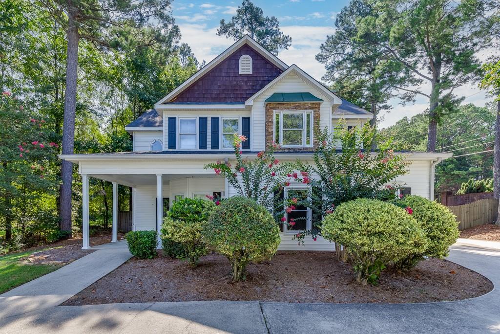 Located in the Magnolia Place community in Lawrenceville, this beautifully maintained 4-bedroom, 2.5-bath home offers comfort, convenience, and thoughtful updates throughout. The home sits on a level lot with a level driveway and features a two-car side entry garage for easy access. A charming front patio welcomes you into the main living space, where an eat-in kitchen boasts white cabinetry, stone countertops, stainless steel appliances, a built-in desk, and a clear view into the cozy family room with a fireplace perfect for everyday living and entertaining. Upstairs, all four bedrooms provide ample space, including a spacious primary suite with an ensuite bathroom featuring double vanities, a separate soaking tub, and a walk-in shower. Additional highlights include updated light fixtures, a finished storage area under the stairs, and a whole-house water filtration system. The backyard is fully fenced for privacy and includes a patio ideal for outdoor gatherings. Conveniently located close to Highway 316 and just minutes from vibrant downtown Lawrenceville, this home blends style, functionality, and accessibility in one desirable package.