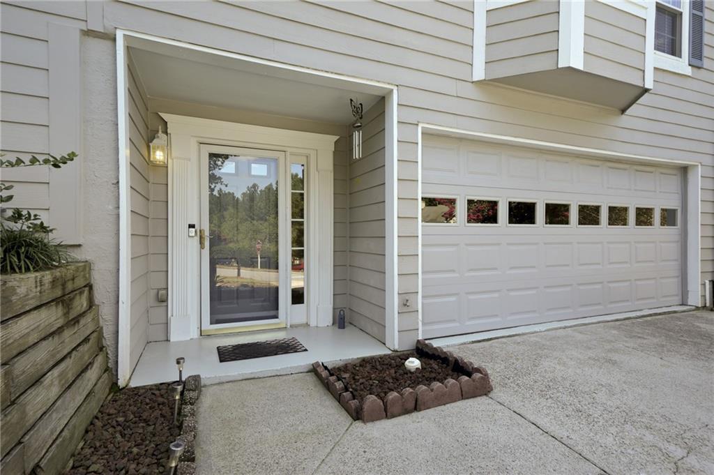 Welcome to this spacious end-unit townhome, offering both comfort and convenience in a prime location. Perfectly situated near golf courses, health care, award winning Gwinnett schools, dog park, walking trails, breweries, Downtown Duluth, and all the shopping, dining, and year-round entertainment you could ask for! Step inside to a peninsula-style kitchen and a sprawling family room filled with great natural light and a cozy fireplace. Main level deck ideal for morning coffee or evening relaxation with wooded views for added privacy. Split bedroom floor plan includes a bedroom and full bathroom on the main level along with an additional bedroom and full bathroom on the upper level for added functionality. Primary suite features a soaking tub, walk-in shower, and a double vanity with a makeup counter. The basement extends the main living area with a hangout or recreation space, or simply use as generous storage to keep things tucked away. With a two-car garage and a private backyard setting, this home is peaceful yet convenient. Enjoy peace of mind with an HOA that covers lawn maintenance and water, allowing for truly low-maintenance living.