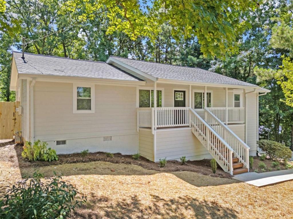 Welcome home to this Completely Renovated hard to find 4BR/2BA Ranch on almost a half acre of flat private fenced back yard in the growing area of Mableton. New new new!!! New "rocking chair" front porch welcomes you into expansive open floorplan. Home features new windows throughout with lots of natural light. New flooring, inside/outside paint with SMOOTH CEILINGS and lots of updates!. Kitchen features a new slow-close white shaker cabinets, new backsplash tile, Quartz countertops, Large Island with additional eat-in area and all new stainless-steel appliances, Large Master bedroom with Master Bathroom features his/her vanities and new Tiled shower, Home features nice size secondary bedrooms, all new interior doors, and new higher-end LVP throughout, New HVAC rounds out this home as move-in ready! Exterior includes all new Siding, new expanded Driveway with turnaround, new back deck, and new Roof! Crawlspace is huge allowing for room for a workshop and storage! No HOA!!! This almost new home offers convenient access to highways, schools, and shopping. Tax records do not reflect 2nd bathroom.
