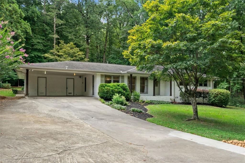 A RARE INCREDIBLE FIND in Smyrna. Convenient to everything near Paces Ferry and 285. Open spacious custom renovated brick ranch. 4 beds, 3 baths.
A private oasis. Entrance foyer, lounging area in the kitchen, new kitchen with quartz countertops, huge island, 36-inch electric oven and gas cooktop, stainless steel top of the line appliances, custom cabinets, new plank floor throughout kitchen, living areas, primary bedroom and bath. Split bedroom floorplan with 3 additional carpeted bedrooms. Open concept large family room with fireplace, dining area and a large sunroom. A private paradise professionally designed backyard includes a large paver family/party patio, with cooking station, pergola and outbuilding. Double carport with one step into the kitchen.
A lot to enjoy here. Not just a nice home, a uniquely private one-of-a-kind home! A private paradise!