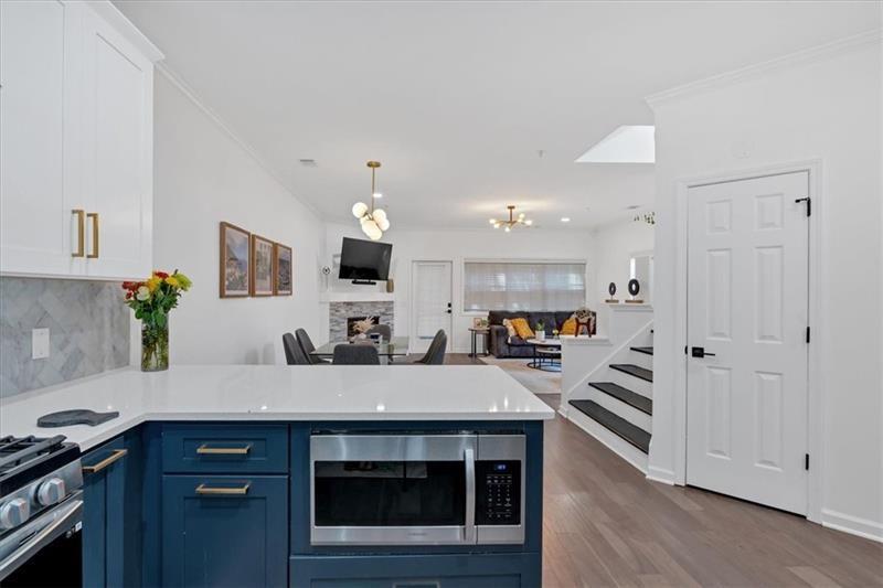 Welcome to your dream home in Smyrna, Georgia! This beautifully renovated 2-bedroom, 2.5-bathroom townhouse boasts modern elegance and convenience, making it perfect for both entertaining and cozy living. Step inside to discover a bright, open layout adorned with brand-new LVP flooring and custom kitchen features. The chef’s kitchen showcases stunning quartz countertops, custom-made cabinets, and new Samsung appliances, including a built-in beverage fridge. A custom pantry closet offers ample storage, while a cozy fireplace serves as the centerpiece of the living area, ideal for chilly winter nights. On the main level, a convenient half bath is perfect for guests, while the second floor features an ideal roommate floor plan with two spacious bedrooms, each with its own beautifully renovated ensuite bathroom. All bathrooms have been updated down to the studs, featuring custom-built cabinets and elegant tile work. Enjoy outdoor living in your fully fenced yard, complete with a firepit for gathering with friends and family. An outdoor shed provides additional storage, ensuring that your space remains clutter-free. Take movie nights to the next level with an outdoor projector—perfect for warm summer evenings under the stars! Located just steps away from Smyrna staples like Smyrna Market Village, Mezza Luna, Rev Coffee, Ruby's Pizza, this home offers the perfect blend of tranquility and urban convenience. Plus, with Truist Park just a 10-minute drive away, you’ll never miss a game! This charming home is a must-see. Don’t miss your chance to make it yours!