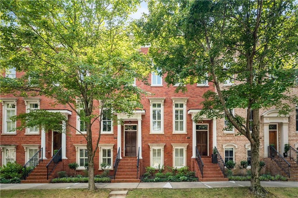 Tucked into the heart of Inman Park & overlooking the most electric stretch of the Eastside BeltLine corridor, this Brooklyn-Inspired Brownstone is absolutely stunning! A rare architectural gem that blends elegant charm with the energy of intown living, this home brings you impossibly close to the very best the city has to offer—think Ladybird, Krog Street Market, Ponce City Market, and Old Fourth Ward Park all just blocks away!
Inside, clean modern lines meet timeless finishes across a sunlit open floor plan. Picture high ceilings, pristine hardwoods, a designer bespoke kitchen with top-of-the-line VIKING appliances, and elegant gathering spaces that flow naturally between living, dining, and entertaining. Upstairs, serene bedrooms and luxe baths offer space to recharge, while a flexible 3rd bedroom/office or studio on the terrace level provides the ultimate in modern living. The primary Suite is drenched with natural light and celebrates a spa-like bath with Carrera tile & free standing tub + a lovely oversized closet. Step outside to your peaceful private balcony complete with newly installed tree decking overlooking the beautifully manicured Inman Village Gardens & Central Park—a true oasis in the heart of the city and daily escape just beyond your door. Including the private pool w/ tanning deck, water feature, and covered lounge area w/ fireplace! A newly epoxied garage is perfect for storage, covered parking, & even a home gym…the possibilities are endless! Built-in Bose sound system including outdoor speakers, custom plantation shutters, and custom closets throughout are just a few of the many upgrades that have been meticulously curated in this beautiful home!
Set on a quiet tree-lined street in one of Atlanta’s most sought-after neighborhoods, Inman Park combines small-town warmth with big-city vibrance, especially when it comes to recreation, retail, & dining. The city’s very best parks are your backyard—from Freedom Park to Historic Fourth Ward and the entire Atlanta BeltLine. From sunrise to cocktail hour, this is city living re-imagined. BRILLIANT!