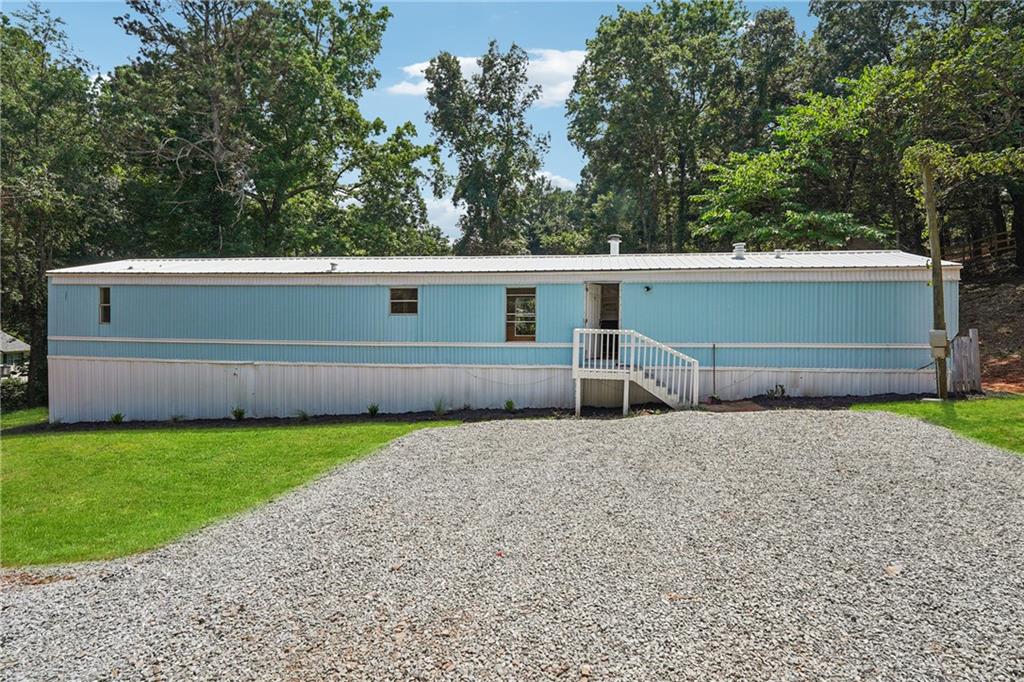 A truly rare find, 4820 Scott Road offers a beautifully updated mobile home sitting on a massive .78-acre double lot (Lot 34 and Lot 35 combined) with extensive road frontage on not just one, but THREE streets—Scott Road, Wisdom Road, and Club Drive—unlocking a world of possibilities. Whether you're envisioning your dream home, an investment rental, new construction, or even a space to store and park equipment, this property delivers unmatched flexibility and opportunity. The large, level lot provides room to expand or repurpose, with no HOA restrictions and endless potential for builders, investors, or owner-occupants. Located in the highly sought-after Forsyth County school district and zoned for the new East Forsyth High School, this is a smart buy in a thriving area with rising property values and high demand. Opportunities like this don’t come along often—act fast before it’s gone! Home is being sold AS IS-WHERE IS with no disclosures, as the seller has never lived in the home. All due diligence must be completed before submitting an offer. CASH ONLY SALE. Seller does not have the title to the mobile home. SURVEY AVAILABLE