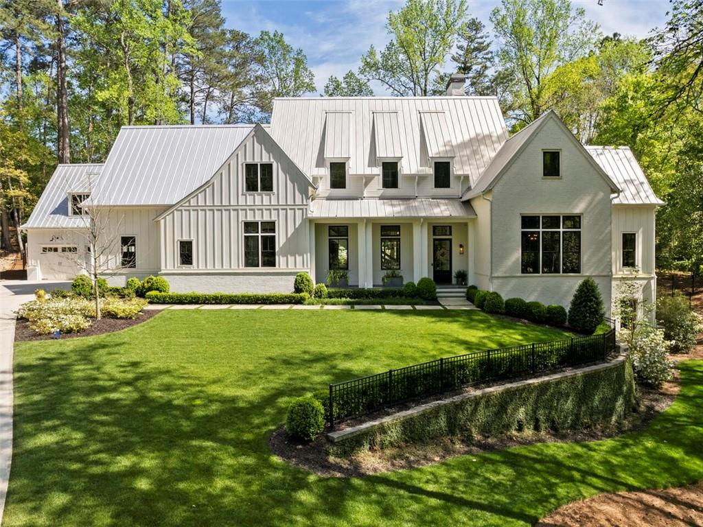 Tucked away on a private cul-de-sac surrounded by mature landscaping, this striking custom home offers modern farmhouse perfection in the city! Architect Marty Marchman collaborated with the homeowners to design this warm and inviting home where no detail was overlooked. The open-floor plan boasts 12 foot ceiling and large expanses of windows creating a true entertainer's delight with a spacious living/dining area, and exquisite kitchen complete with high-end Wolf and Sub-Zero appliances flowing to a beautiful walk-out backyard with saltwater pool, Bluestone patio, outdoor kitchen, and living room complete with a cozy fireplace. The main level also features a spacious office, a mudroom off the large four-car garage, and an inviting owner's suite with vaulted ceilings, luxuriously appointed bath, dual closets, and laundry room. Upstairs, you'll find four en suite bedrooms and flex space with an additional laundry room. The finished lower level includes an en suite bedroom, game room, gym, bar and half bath. Enviable location minutes to numerous shopping & dining options in Brookhaven, Sandy Springs and Buckhead plus easy access to GA400 and I-285. Don't miss the opportunity to own this dream home!