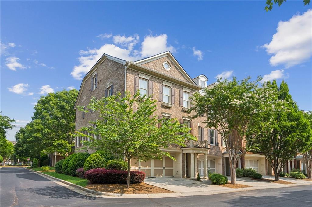 Finally a townhome that lives more like a home. End unit with 2-car garage features wonderful open concept living space with walls of windows and light. One of only a handful of units with large picture window and private views from every room in the house. Well situated within the community to take advantage of guest parking, and close to amenities which include community pool, exercise room, clubhouse. Fast access to GA400 and walking distance to Amphitheater, North Point Mall (redevelopment project in the works!), The Gathering, and on Alpha Loop (in progress). More to love is the well-planned floor plan, including a large kitchen with island, gas cooktop, large pantry and plenty of cabinets and counters. The first floor is perfect space for guest room or keep as movie/entertainment room. Primary and additional secondary rooms upstairs, creating a feeling of penthouse living with unobstructed views. Move right in and make this one home.