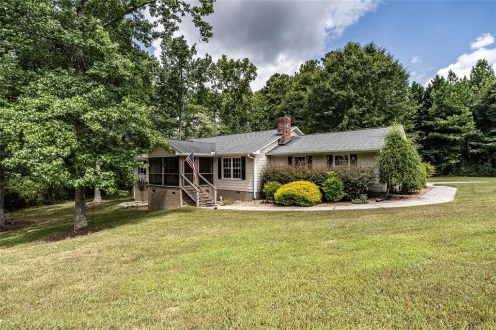 Beautiful 4-bedroom, 3-bathroom home on 2.53 acres in Highpoint subdivision! This well-maintained property features an open kitchen that flows into the dining area and a spacious living room with a cozy fireplace. The oversized primary suite includes a walk-in closet and a gorgeous tile bathroom with a custom shower. Additional bedrooms are spacious, many with walk-in closets. Enjoy hardwood floors, plenty of storage, and an attached 2-car garage. Relax on the screened-in front porch and enjoy the privacy of the large, fenced backyard. Don't miss this opportunity!