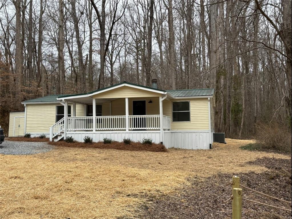 READY AND WAITING!!! RECENTLY REMODELED 3/2 DOUBLE WIDE WITH NEW HVAC, HOT WATER HATER, PLUMBING, INSULATION, WINDOWS, FLOORING, PAINT, LIGHTS, STAINLESS APPLIANCES INCLUDING REFRIGERATOR, GRANTE COUNTERTOPS. GREAT PRIVATE LEVEL 1 ACRE LOT WITH CREEK. CONVENIENT TO GA 400 AND SCHOOLS, SHOPPING. ENJOY SITTING 0N THE OVERSIZED FRONT PORCH AND LISTENING TO THE CREEK. INVESTOR OWNED, SOLD WITHOUT A SELLER'S DISCLOSURE. MOBILE HOME TITLE IS RETIRED, SELLER HAS STRUCTURAL ENGINEER REPORT.