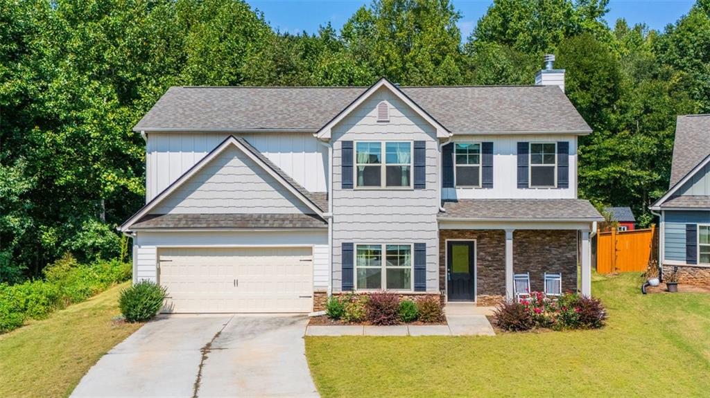 Welcome to this charming Craftsman-style home in the serene, gated community of Sutton's Landing featuring brand new Pickleball Courts and Swimming Pool. This BETTER THAN NEW Home has ample storage, a very private backyard and screens on all the windows. The front porch has features classic stacked stone which leads right into an open-concept layout. Arched doorways and a soft neutral palette create a warm, elegant atmosphere. The kitchen flows seamlessly into the main living area—perfect for entertaining or everyday living. The spacious master suite offers a peaceful retreat with a spa-inspired bath featuring a double vanity and a custom, floor-to-ceiling tiled shower with built-in shelving. Additional highlights include: Two extra storage closets—one in the downstairs hallway and one in the laundry room (not found in the new builds). Screens on all windows for added comfort. Updated soaking tub in the non-primary bath with custom tile and a built-in shelf. Enjoy tranquil evenings on your private, covered back porch surrounded by nature. This home blends timeless design with thoughtful upgrades—welcome home!