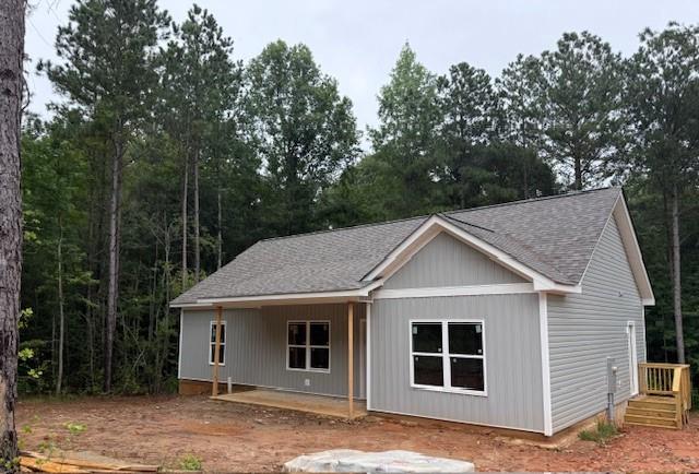 Beautiful Ranch Style Home on 3.1 Wooded Acres!! No HOA! Enjoy peaceful country living in this gorgeous 3 bedroom, 2 bath ranch home set on a private, wooded 3.1 +- acre lot. With No HOA and not in a subdivision, you'll have the freedom to make this home truly your own. Step inside to an open concept layout featuring a vaulted ceiling in the living room and the dining room! The kitchen features stainless steel appliances, a breakfast bar, pantry, and granite countertops! Convenient main level laundry room makes daily living a breeze! The master suite boasts a tray ceiling and master bath with a double vanity plus an oversized tiled stand-up shower. With split-bedroom style for added privacy, the two additional bedrooms and full bath provide ample space for family or guests. You can also look forward to relaxing on the covered back porch and take in the beauty of your wooded surroundings. This home combines comfort, style and privacy! Perfect for those seeking a serene country setting while staying close to modern conveniences. Approximate completion date is 45 days from contract date!