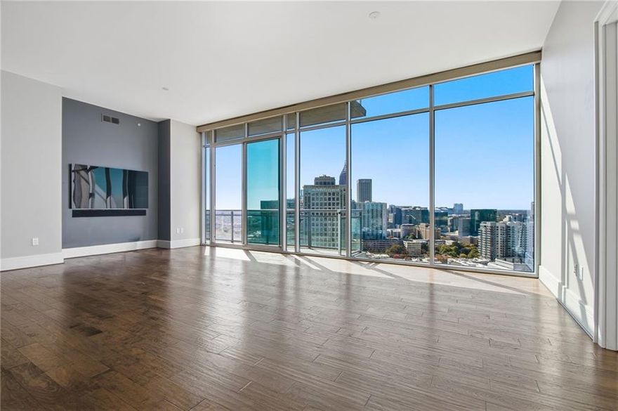 Experience elevated Midtown living at its finest from this luxurious 33rd-floor residence perched above the Loews Atlanta Hotel.

Enjoy sweeping, unobstructed views of Midtown, Downtown, and Piedmont Park from every room of this impeccably designed home. The spacious open layout offers a seamless flow between the living, dining, and kitchen areas — perfect for both entertaining and everyday living. The oversized primary suite provides a serene retreat with automatic blackout shades, a custom walk-in closet, and a spa-like ensuite bath featuring a Victoria + Albert soaking tub and separate shower. The guest suite offers privacy and comfort for visitors or an ideal home office.

Every detail has been thoughtfully upgraded, from hardwood floors and custom cabinetry to high-end kitchen appliances, smart home features, and an integrated audio-visual system. Electronic shades and mounted TVs in each room remain with the home, creating a truly turnkey experience.

Residents of 1065 Midtown enjoy exclusive access to the private owner amenities above the Loews Hotel, including a heated rooftop pool, clubroom, and 24-hour concierge. Ownership also includes direct elevator access to Exhale Spa & Gym, valet service, and in-room dining from Ashland Restaurant.

With only 52 private residences above the hotel, 1065 Midtown offers a rare blend of privacy, security, and resort-style luxury. Two deeded parking spaces, same-level storage, and a private gated entry ensure convenience and peace of mind. Just moments from Piedmont Park, the BeltLine, the High Museum, and Atlanta’s top restaurants and nightlife, this residence captures the very best of urban sophistication.