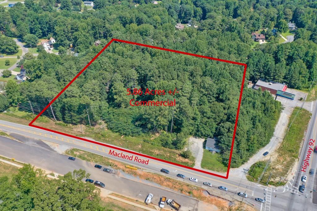 Property is near major intersection in one of the fastest growing counties. Excellent road frontage. 5.86 +- Zoned B1, Great location for medical/office building, small grocery store/fuel, auto service, so many options. Scheduled to be 4 lane that goes to Douglasville, Macland Road goes to I75 near Truist Park. Close to Paulding/Cobb Line, Hospital. Approximately 3.5 +- miles to Starbucks and Publix Great Opportunity!