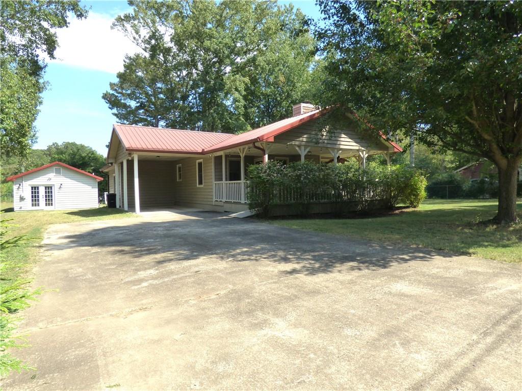 Escape to this charming 2-bedroom, 2-bath cottage nestled in an established, tree-lined neighborhood with no HOA. Enjoy quiet moments on the huge front porch with an accessibility ramp or on the rear screened porch and deck. The cottage features a durable metal roof, cement siding, and a cozy fireplace. Inside, LVP flooring and ceiling fans enhance comfort throughout, no carpet here! A new HVAC and a freshly serviced septic system provide peace of mind. Don't miss the detached 620 sqft, 1-bedroom, 1 bath apartment with a kitchen that offers additional living space for relatives or rental income. Walk to Adairsville High or Middle schools, with downtown just a short trip away. Only 1 mile from Manning Mill Park.