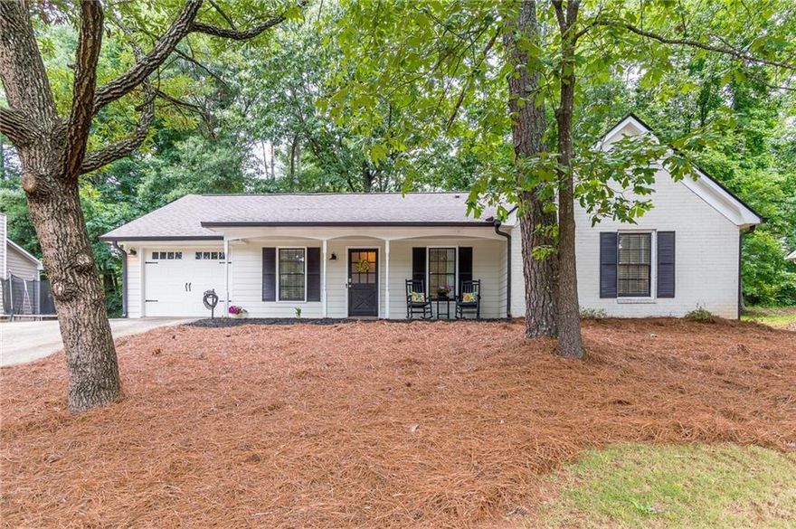 Absolutely charming and just .06 miles to the heart of Historic Downtown Norcross! Restaurants, retail, parks/trails/recreation and local entertainment only moments away! This home has been recently renovated and is move-in ready! Great floorplan with 3 roomy bedrooms, gorgeous baths and luxury (LVP) flooring through-out. Large, sun-drenched family room with stone surround, raised hearth, fireplace. Separate dining room opens to the kitchen and has wide views of the large, fenced backyard. Beautifully appointed modern kitchen with white cabinets, pantry, quartz counters, subway tile backsplash and stainless-steel appliances, plus a HUGE separate laundry room with room for storage or desk space all with convenient, walk out access to the garage! The oversized Primary suite has a walk-in closet and a large walk-in shower! Step out to the fully fenced backyard with a stone patio, firepit and so much space to grill, garden, play with the pups, set up your favorite yard games or a playset, endless possibilities... All newer systems, windows and roof. This home is warm and welcoming and has everything one could ever need.
