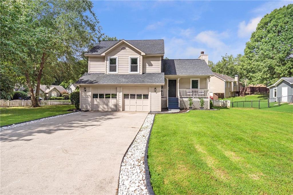 Don't miss your opportunity to see this move in ready home in Sugar Hill! Features of this home include a welcoming front porch, a flat yard perfect for playing, updated 1/2 bathroom and hall bathroom, and no carpet! The flooring for the entire home is luxury vinyl! The main level hosts a spacious family room with a gas fireplace and wonderful windows letting in so much light! Upstairs are two secondary bedrooms and a hall bathroom, and the primary bedroom with en suite bathroom and a walk in closet. The lower level is where you will find the large kitchen which has enough space to accommodate an eating area, as well as space to make as a keeping room. If you want to add an island, there is plenty of space for that! A double door off the kitchen leads to the back yard and patio, making outside grilling convenient! This home is a quick drive to Downtown Sugar Hill, major roads and highways, and is NOT in an HOA! No rental restrictions. Bring your boats and trailers!