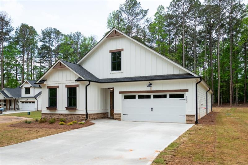 An enclave of eight custom homes minutes from Villa Rica and near the Roses store and Hwy 120 intersection. You will enjoy 3 bedrooms and 2 bathrooms on the main as well as an additional bedroom and bathroom upstairs. Master bathroom features a large shower with corner bench and tower cabinets for your towels and linens. This Beautiful open floorplan has lots of windows for natural light, white cabinets, kitchen island with sink and view of the family room which boasts a gorgeous rock fireplace with cabinets and shelves on each side. Total electric with gas starter fireplace and the option of gas cooking and gas grill hookup. So many added features from the window boxes out front to the covered porch and patio area. No HOA and on a cul-de-sac lot. Map on FMLS is incorrect.