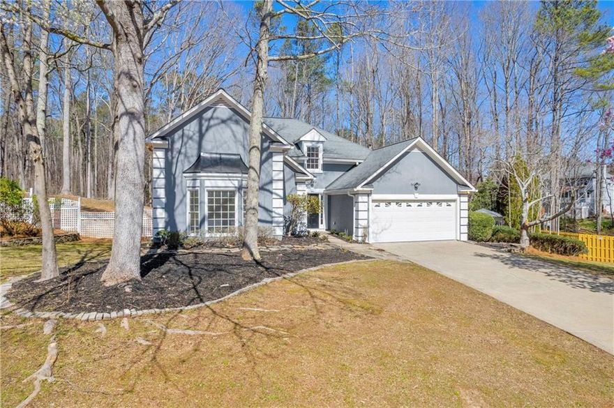 Welcome to your dream home in the prestigious and highly sought after neighborhood of Lee's Crossing which earned the coveted "2023 Best of Cobb" for it's low HOA and champion swim/tennis teams. Nestled near Marietta Square and Kennesaw Mountain Battlefield, this location offers the perfect blend of history and modern living.

Situated on almost an acre of lush land and backs up to a national park, this home boasts unparalleled privacy and space. It has been completely renovated from top to bottom without a single detail being left out. All new floors, new paint, new fixtures and updated kitchen and bathroom- you wont want to miss this gem! The main level features a serene Primary Bedroom with direct access to the back deck, inviting you to unwind and enjoy the tranquil surroundings.

The basement of this house is a hidden treasure, ideal for accommodating guests or extended family, or even space for the teenagers to have to themselves! With two bedrooms, a versatile bonus room, a full bath and a convenient mini kitchen, it's the perfect setup for a private retreat.

Step outside and discover the immense backyard, providing ample room for outdoor activities and entertainment. Outside you will also find your very own greenhouse and Gazebo along with an expansive back deck. You will truly feel like you are in your own peaceful oasis.

Lees Crossing is renowned for its outstanding amenities including a saltwater pool, playground, tennis courts, clubhouse and even pickleball courts. Whether you are seeking relaxation or recreation, this neighborhood has something for everyone. Don't miss out on the opportunity to call this stunning house your home.