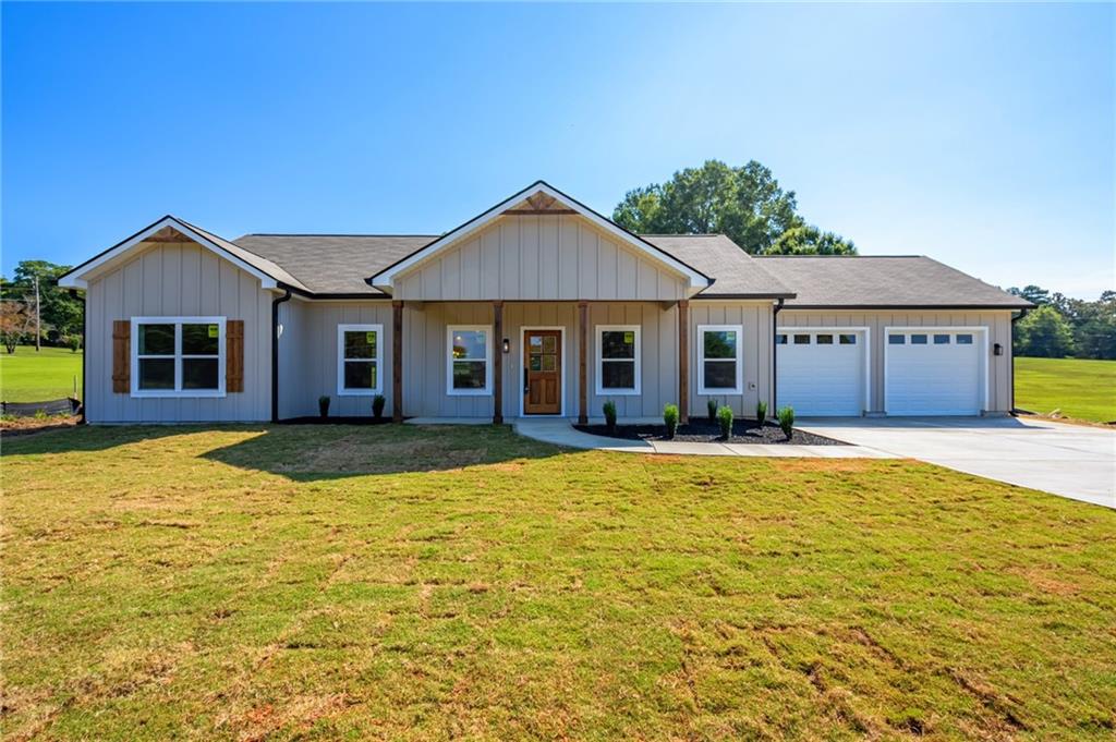 Located just minutes from schools, shopping, dining, Polk Medical Center, and with easy access to Highway 27 and 278, this beautiful new construction home offers luxury living in a peaceful cul-de-sac setting with a rural feel. Step inside to discover high-end finishes throughout, including a dramatic 12-foot vaulted ceiling with a floor-to-ceiling custom fireplace, 9-foot ceilings throughout the rest of the home and custom real wood cabinetry paired with elegant quartz countertops. The open-concept floor plan is perfect for both daily living and entertaining, with the master suite thoughtfully positioned opposite the secondary bedrooms for added privacy. Luxury Vinyl flooring throughout including in the master, with tile floors in bathrooms and tiled showers. The spa-like master bathroom features a free-standing tub, glass-enclosed tile shower, and a spacious walk-in closet. The chef’s kitchen is fully equipped with stainless steel appliances, 6-foot island, soft-close cabinets, tile backsplash, and a kitchen sink window offering a stunning view of the wooded backyard. Enjoy meals or entertain in style with double mahogany doors that open from the dining area to the serene forest view. With a nearly 200-foot setback from the street, the expansive front yard and long driveway create a grand first impression. The back of the property has an almost 500-foot x 12-foot-wide strip ready for any of your outdoor adventures, hiking trail, ATV trail or just enjoying the view! An oversized garage offering 24 ft x 24 ft of space and 9-foot ceilings also offers room to store your off-road vehicles.
This home qualifies for USDA, FHA, and VA financing with ZERO MONEY DOWN or down payment assistance options for qualified buyers. $500 incentive toward closing costs with preferred lender. Seller is contributing up to $1,000 towards a home warranty and also providing a transferable termite warranty.
Don’t miss this rare opportunity to own a luxury home on acreage in a quiet, convenient location!