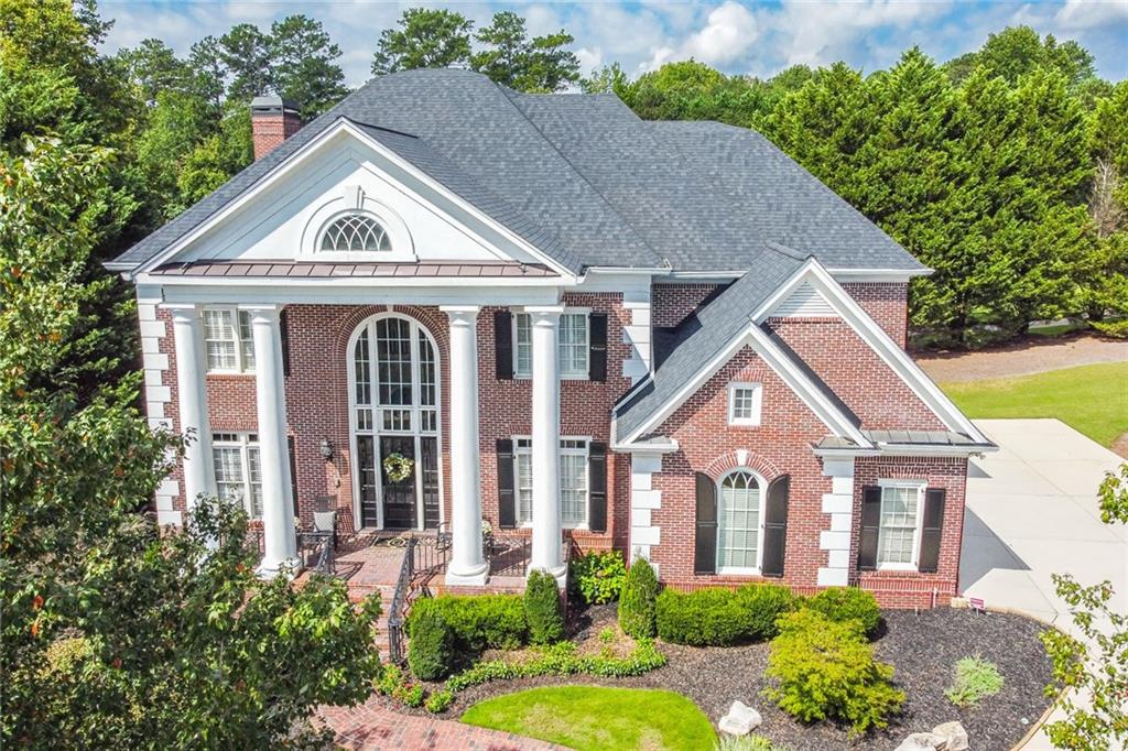 HONEY STOP THE CAR!! UNBELIEVABLE PANORAMIC VIEWS OF 3RD FAIRWAY JUST BEGINS TO DESCRIBE THE EXCITEMENT THIS STUNNING NEW SUGARLOAF LISTING BRINGS… Massive tall, thick columns- reminiscent of The White House, greet you to this Georgian/ Charlestonian architectural style home… Spotless immaculate in care (and pet free), enter home to two-story foyer with heavy trim… Private paneled home office; HUGE formal dining room to fit 12; custom glass-shelved liquor/ beverage wall. Butler’s pantry with ice maker. Elegant Grand Room with wide-open golf views… Gourmet kitchen with double-ovens and all the features that the best of chefs would desire… Easy walk-out from kitchen leads to very entertaining deck. Upper level of home is VERY unique- all bedrooms with own private bath suites. Master up suite features: beautiful gas-starter fireplace; sitting room; HUGE HUGE master BR walk-out balcony overlooks all the golf action! And lastly, large owner’s closet… Terrace level is handsomely finished featuring: Billiard/ pool room; second Grand Room or media room; bedroom; full bath; kitchen/mini bar; and storage center with electronic home center. Some add’l features to this home: Instant whole-house hot water system; 50-yr high performance architectural roof; epoxy-coated 3-car garage- looks like a Porsche showroom! Whole-house electronic surge protection system; dry-under deck system; whole-house music network. All TVs remain; top-quality washer & dryer remain; all refrigerators remain… Superior all-brick construction. And located in the heart of quiet cul-de-sac. PRICED TO SELL!!! World-class country club guard gated community boasting famous Greg Norman signature 27-hole TPC golf; 60,000 sq ft clubhouse; numerous restaurants; stunning swim/ tennis/ gym facilities; and dozens of year round social & athletic activities. Showings begin Monday the 18th…