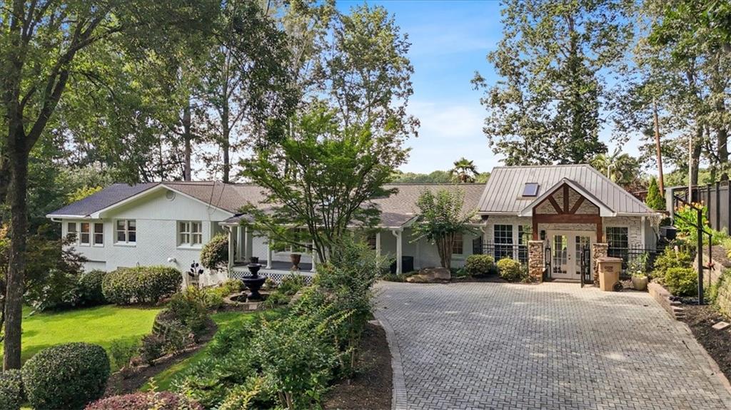 A Southern Traditional Ranch with a Guest House! 1+ acre lot with lush landscape,landscape lighting and a newly sodded backyard! NO HOA!! The Main House and the Guest House each offer 4 bedrooms and 3 bathrooms. This Incredible Family Compound is the perfect setting for multi-generational living. The Main House has a keeping room, family room, home office, flex/bonus space, a kitchen on the main floor and a kitchenette in the basement, as well as two laundry spaces. Ample storage space is available on both levels. A kitchen island, walk-in pantry, real laundry room and custom cabinetry are on the main floor. A covered front porch and covered back porch allow you to enjoy the peaceful settings of the landscaped yard, soothing water features and outdoor lighting. The full finished basement is a great spot for a teen/in-law suite. The Guest House has an open concept kitchen/dining/family room, two bedrooms and a full bath on the main floor and two bedrooms, two bathrooms and a laundry room upstairs. The Guest House has a separate driveway and loads of parking space. This unforgettable property also boasts two outbuildings for storage, hobbies or workshop space and RV/boat/equipment parking. Minutes to shopping, dining, and top-rated schools. This one-of-a-kind property won't last! Convenient to I-575 at exit 14. Schedule your private showing today!!