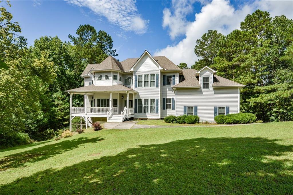 Southern charm meets modern living! This 4-bedroom, 3 full/2 half bath home on 4.3+ private acres offers wraparound covered porches, timeless curb appeal, and a thoughtful floor plan designed for comfort and style. Inside, hardwood floors flow from the foyer to a formal dining room and a flex room with custom moldings. The living room features a cozy fireplace with a wood shiplap accent wall, opening to a gourmet kitchen with granite countertops, stainless steel appliances, tile floors, tile backsplash, walk-in pantry, raised bar seating, and a gas range. A bay-window breakfast nook overlooks the backyard, and French doors lead to an expansive back deck. The mudroom off the 3-car garage includes a custom bench, built-in storage, and utility sink.
Upstairs, the primary suite boasts a fireplace, private balcony, huge walk-in closet, and a spa-style bath with French doors, double vanities, a garden tub, and a double-headed custom tile shower. Two bedrooms share a Jack-and-Jill bath, and the fourth bedroom is an expansive, versatile space—perfect for a media room, playroom, home gym, or retreat.
The full, partially finished basement is stubbed for a bath with a sink and commode already in place, plus a boat door, utility sink, and space ideal for a workshop or boat/golf cart parking. From here, step out to the covered terrace-level patio and fenced backyard. Privacy, versatility, and Southern style await—prime location with nearby conveniences.