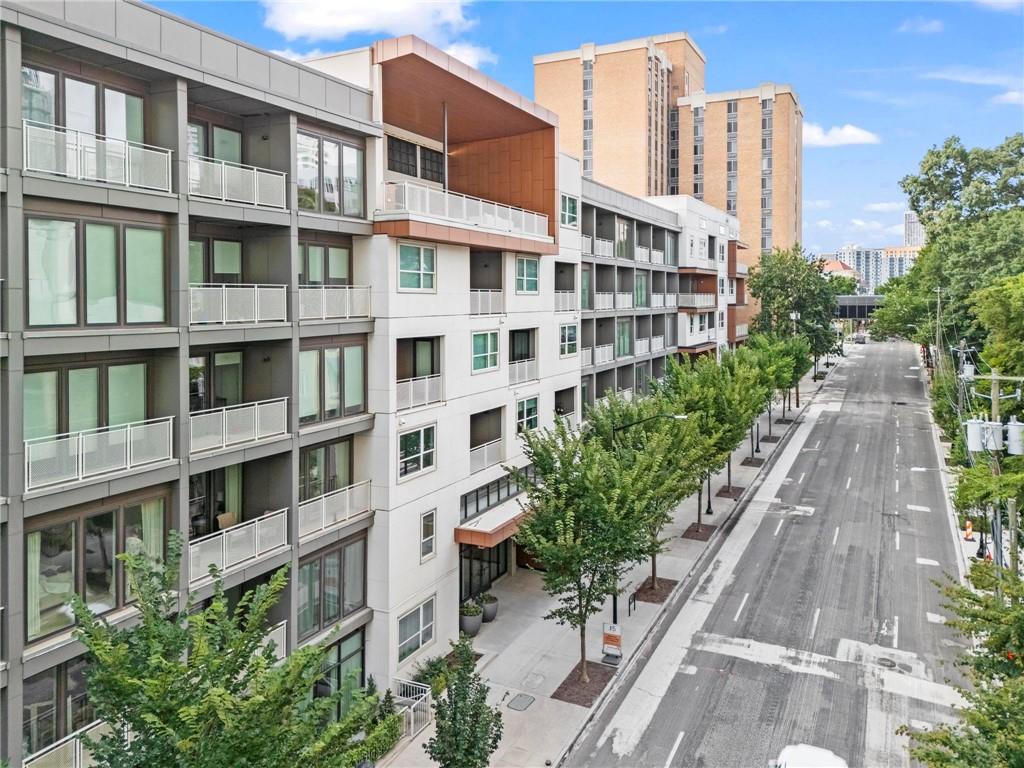 Amazing opportunity for a turn key, BETTER THAN NEW unit in Midtown’s coveted J5 building! Barely lived in for the last 15 months, the Seller has made this unit truly move-in ready for the next owner. Custom window treatments, stainless steel fridge, and fully built-out closets are completed upgrades that are not included in other units for sale by the developer. Buyers will love this preferred floorpan ideally perched above Juniper boasting an open concept entertaining space and split bedroom layout. The chef’s gourmet kitchen features designer touches like quartz countertops, high-grade cabinetry, premium appliances, large island, and a sizable pantry. Abundant natural light from the oversized windows overlooking the Midtown skyline and a comfortable balcony round out the common spaces. The primary suite is a serene oasis with massive walk-in closet and luxurious bathroom showcasing dual vanities and a stunning tile shower. Amazing city views and a large walk-in closet make the secondary bedroom a truly comfortable space. The additional washroom is oversized and again features dual vanities, a tub/shower combo and a custom linen closet cabinet; any visitor will surely be impressed! Stacked washer/dryer combo is included with the sale and makes the inevitable chore a bit more manageable. Two assigned parking spaces in the gated and secured garage plus a private storage unit (a $10k premium when purchased new) complete this city home. J5 is the newest owner-occupied building in the heart of Midtown with world-class amenities such as a large outdoor pool, private gardens, onsite fitness center, pet center, and 24-hour concierge. High WalkScore means you’re only steps from endless shopping, dining, and nightlife destinations in Atlanta’s activated Midtown neighborhood. Year round fun at Piedmont Park and the Eastside Beltline Trail can’t be beat. Welcome home to Unit 413 where life is good and living is easy!