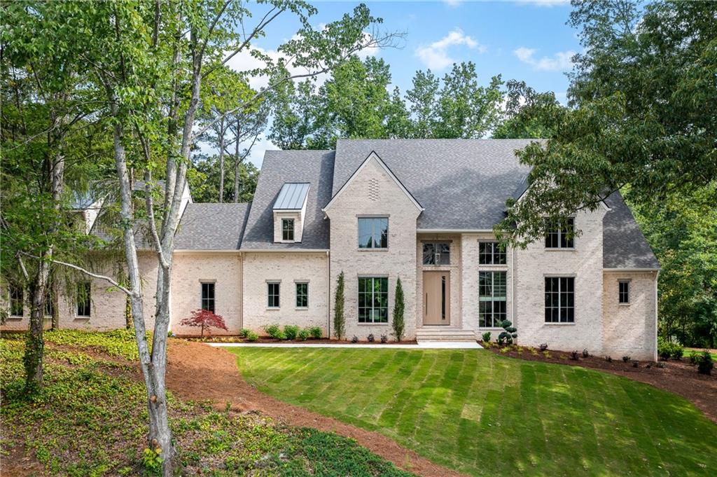 Motivated Seller. This newly constructed estate has all the modern touches for today’s discerning home owner. Designed by Build Magazine’s Best Green Luxury Home Builder 2023, Legacy Custom Homes & built by EarthCraft Certified DJF Design, LLC, this home has it all. Located on prestigious Heards Ferry Road, this 1.16 acre property features 5 Bedrooms, 6 full baths, 2 half baths, a 3-car garage and a large flat backyard with room for an oversized pool. The 2-story foyer is sure to impress with a 10’ tall pivot door, gas lite front porch and modern iron staircase flooded with natural light. The open floor plan features a chef's kitchen with views to the great room, covered deck and back yard. The window wall in the eat-in-kitchen opens to the covered back deck with fireplace, allowing you to experience resort-like living. Luxury appointments throughout include: custom designer white oak cabinetry, French oak wide plank flooring, Thermador appliance package, impressive oversized 10’+ Taj Mahal granite island. Natural light floods into the house from every angle, allowing you to appreciate details like the white oak beams in the great room. An updated open floor plan balances flow, noise control and privacy needs for a busy family. A formal dining room and private office/sitting room provide the perfect setting for more intimate gatherings. The main level also features 2 beautifully appointed half baths and a home office. Organization will be easy when you have a large walk-in pantry and a spacious mudroom with lockers and built-in drop spot. Comfort greets you from every angle when you wake up to morning light in your first-floor primary suite with a spacious double shower, soaking tub, heated floors. The added convenience of a secondary laundry adjacent to his & hers closets enables you to complete your personal laundry in private.
The second-floor features 3 generous bedrooms with ensuite bath and walk-in closets. The second-floor laundry has designer tile and plenty of room to keep even the dirtiest of kid’s clothes concealed. There is an additional playroom and a separate yoga/meditation/massage room.
Don’t forget the bonus 5th bedroom over the garage. Perfect for au pair suite, teen apartment or a space to claim as an Owner’s get-away.
Spread out with family and friends on the finished Terrace level. Ten-foot ceilings & wide windows provide a spacious feeling for any large gathering. There is plenty of room for a ping pong or poker table. And room as well for a bar in the recreation room. The adjacent family room is already prewired for 6.1 surround sound for those family movie nights or teen gaming.
A full bath with door to the outside offers convenience when you need to hose off dogs or children. The gym is large enough for commercial size equipment. Two mechanical rooms hide the homes smart offerings while also providing ample room for season storage.
Outside you’ll find the perfect oasis of golf course quality grass for sporting activities. You might even add a luxurious custom pool to complete your private resort. Storage for all your sports activities is easy with the extra-large outdoor storage area separate from the garage.
Today’s modern estate homes are draft free and feature superior climate control insuring comfort, quiet, and low maintenance. You’ll find many energy features including: spray foam insulation, 5 zones of HVAC control, Aluminum clad windows, tankless water heater and advanced building techniques to maximize energy efficiency.
Schedule a walk-through with the Builder who can talk specifics about the home & any customizations that might be needed.
This prestigious estate is conveniently located in the award-winning Heards Ferry Elementary School District, and the high school is Riverwood International Charter School. Less than 1 mile to I 285, 5 to 20 minutes to Sandy Springs City Center, Perimeter Mall, Chastain Park, Truist Ball Park and the River Park
