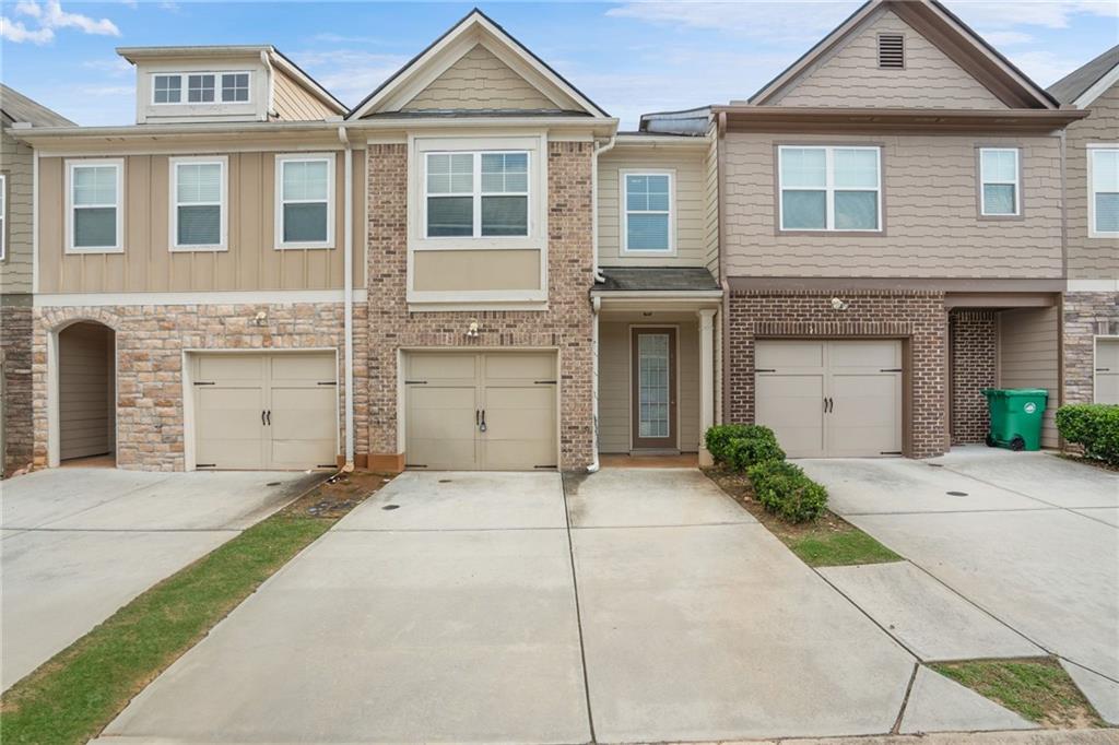 Absolutely exquisite! Presenting an exceptional opportunity to rent a stunning townhome IN A GATED COMMUNITY with a 1-car garage in the thriving Decatur area. This residence is nestled within a gated community, offering an exclusive living experience. Step inside and be greeted by a true culinary masterpiece – a Gourmet Kitchen adorned with sleek quartz countertops and an array of top-of-the-line stainless steel appliances, including a refrigerator and washer/dryer ensemble. The kitchen seamlessly flows into the Living/Dining Room, where a cozy fireplace sets the perfect ambiance for both relaxation and entertainment. Enhancing the allure of this space, hardwood floors gracefully extend throughout the lower level. Retreat to the Master Bath, a sanctuary of elegance and comfort. Dual vanities with exquisite countertops, upgraded tile floors, a rejuvenating jetted garden tub, and a separate glass-enclosed shower with a built-in seat create an indulgent spa-like experience. Step outside and experience an oasis of tranquility in your fully fenced backyard, complete with a delightful patio. The HOA takes care of the yard maintenance, allowing you to relish the outdoor space hassle-free. Conveniently located near major highways 285/20, this townhome offers seamless connectivity. And that's not all – a plethora of thoughtful upgrades enhance the charm and value of this remarkable property.