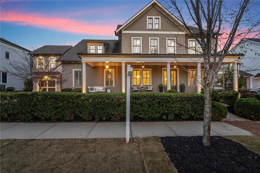 Experience elegance in this exceptional custom-built estate perfectly positioned in the heart of Crabapple. Move-in ready and designed for both grandeur and comfort, this exquisite home offers a seamless blend of sophisticated style and modern convenience. A spacious front porch welcomes you into a light-filled interior with soaring ceilings, extensive millwork and wide-plank hardwood floors. The gourmet kitchen is a chef’s dream showcasing an expansive island, designer finishes and views of both the fireside keeping room and the inviting living room—each space flowing effortlessly to the private covered patio and serene outdoor retreat. A separate formal dining room offers an elegant space for hosting, while the butler’s pantry provides additional prep and storage space for effortless entertaining. The primary suite on the main level is a true sanctuary, boasting a spa-like bath, designer finishes and a large walk-in closet. Upstairs, three oversized secondary bedrooms each offer en-suite baths, walk-in closets and an abundance of natural light. A third-floor media room provides additional space for relaxation or entertaining.  A spacious mudroom leads to an outdoor covered walkway connecting to the detached carriage house which offers an oversized finished room and a full bath for endless possibilities—whether as a private guest suite, home office or personal retreat. The three-car garage ensures ample storage and convenience. Nestled on a private, tree-lined lot with picturesque park views, this home is just steps from Crabapple’s charming boutiques, acclaimed dining and top-rated schools. Enjoy an unparalleled lifestyle with a Junior Olympic-sized pool, scenic parks, and walking trails. Lawn maintenance is included, allowing for truly effortless living. This is more than a home—it’s an invitation to experience timeless elegance in one of the most coveted locations.