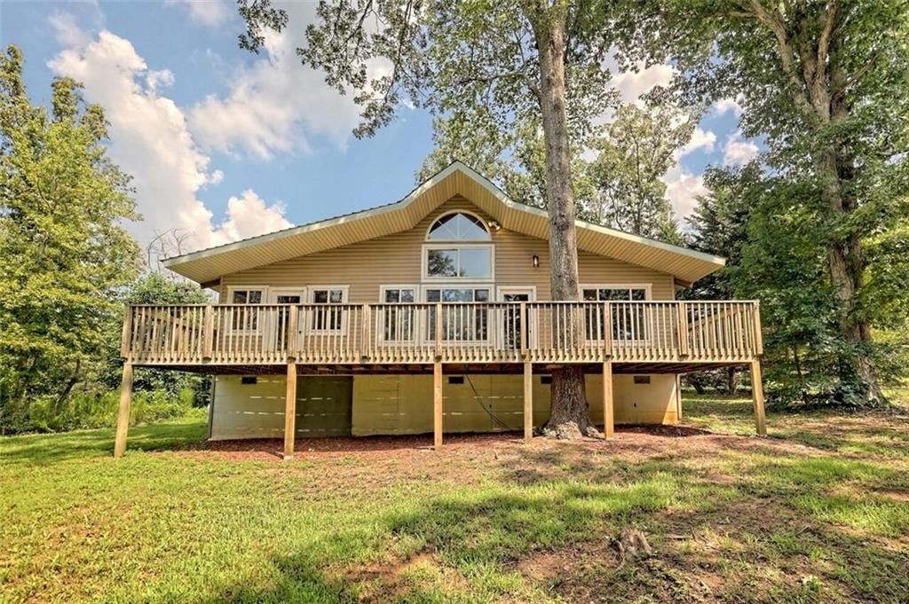 CHARMING UNIQUE COTTAGE ON 2.69 UNRESTRICTED ACRES... Located in a quiet setting off the beaten path and only minutes from Hwy 441/365 for the commuter and a short drive to Downtown Clarkesville for all your shopping, dining, and entertainment needs. This home also features a cozy family room with hardwood floors, tongue and groove ceilings, exposed beams with a highly desired open concept design with a loft. The main level flows nicely to a super functional kitchen with island breakfast bar and abundance of cabinetry for storage. Easy access to a large back deck for grilling out and entertaining guests.
